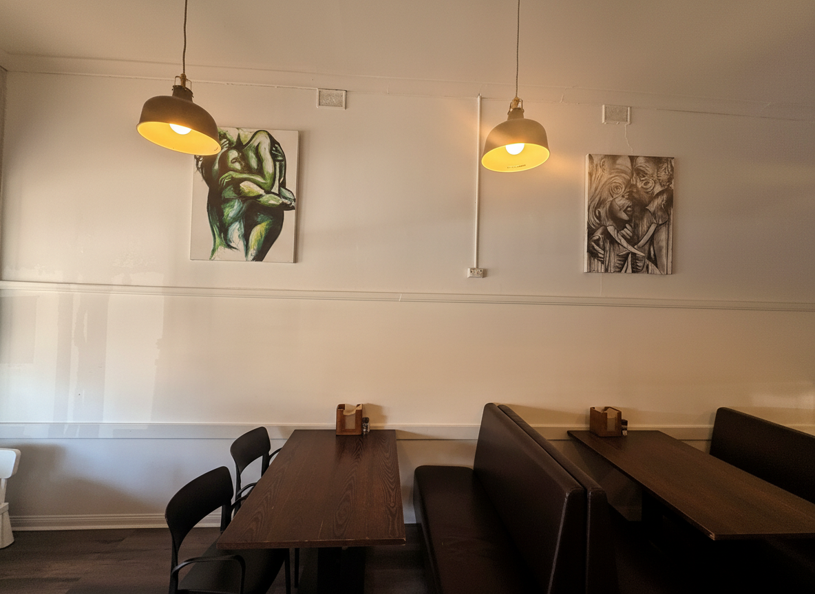 Renovated dining room with pendant lights and local artwork